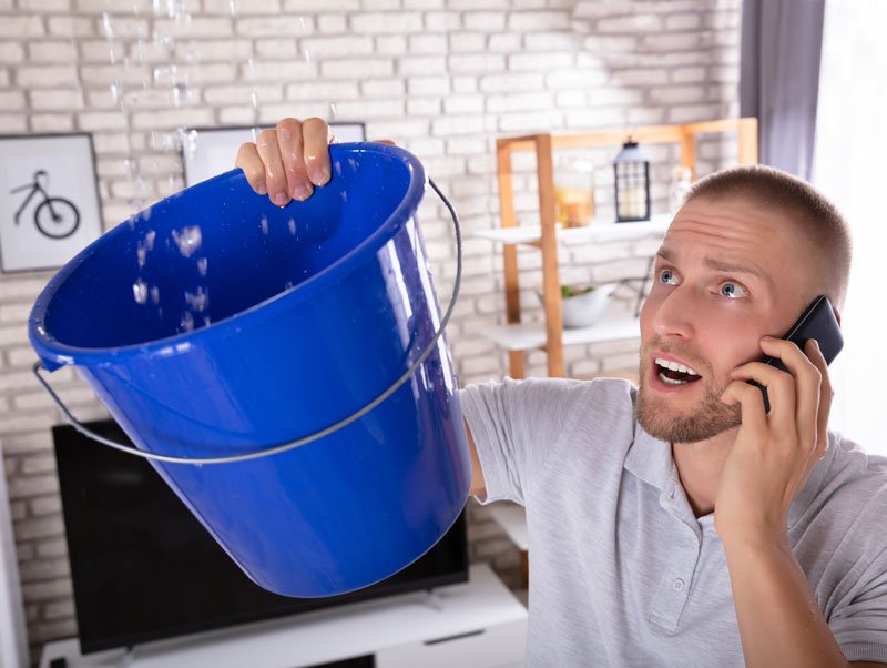 Man catching falling water with a bucket calling for help